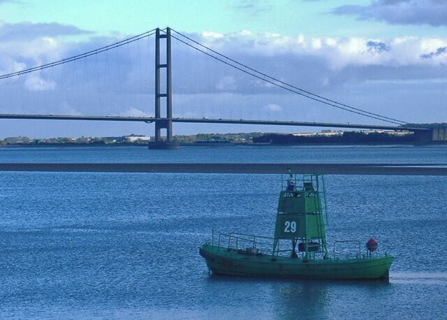 Humber buoy, from the shore east south east of North Ferriby, East Riding of Yorkshire, England. The little green boat I think must be an aid to shipping in the Humber, marking the deep water channel. In the background is the Humber Bridge (south tower). The same buoy is also pictured a year or so earlier at SE9921 : Channel Buoy 29 where it is on the opposite side of the Humber, showing presumably the degree of movement in the estuary's sandbanks.