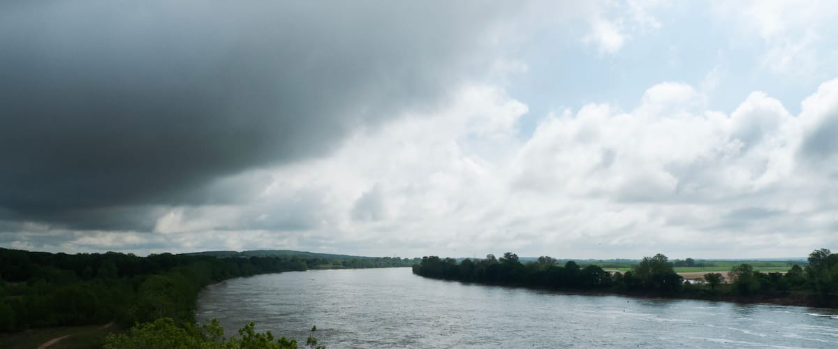 Arkansas River south of Sallisaw, Oklahoma, river is full, storm clouds