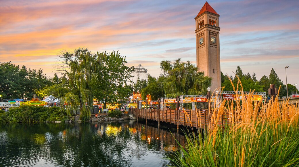 Festival goers enjoy a colorful sunset at the annual Pig out in the Park at Riverfront Park along the Spokane River in Spokane, Washington