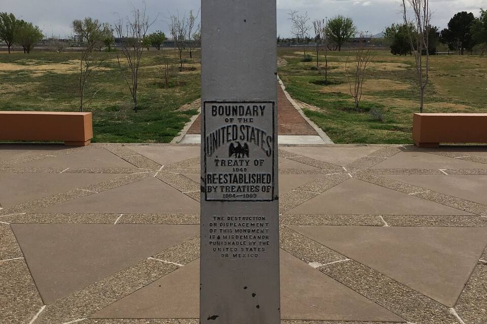 A tall, weathered monument with inscriptions about the boundary of the United States and treaties of 1848-1849.