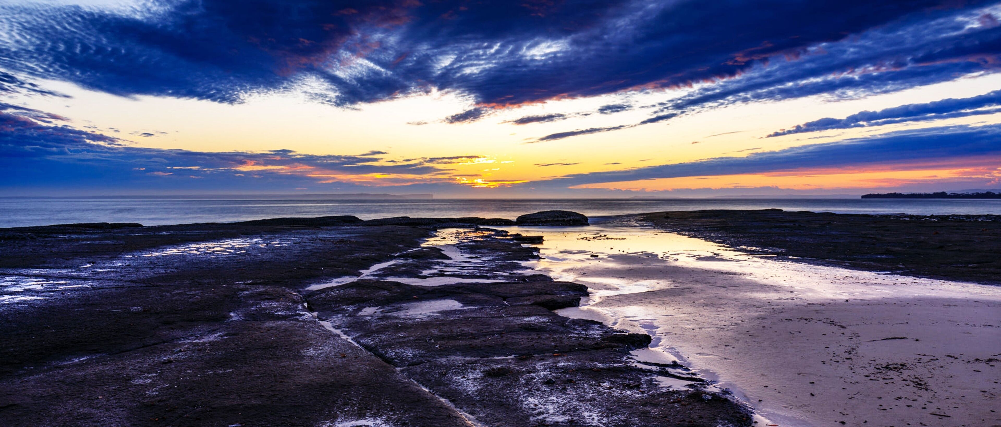Cloudy sunset sky over a beach