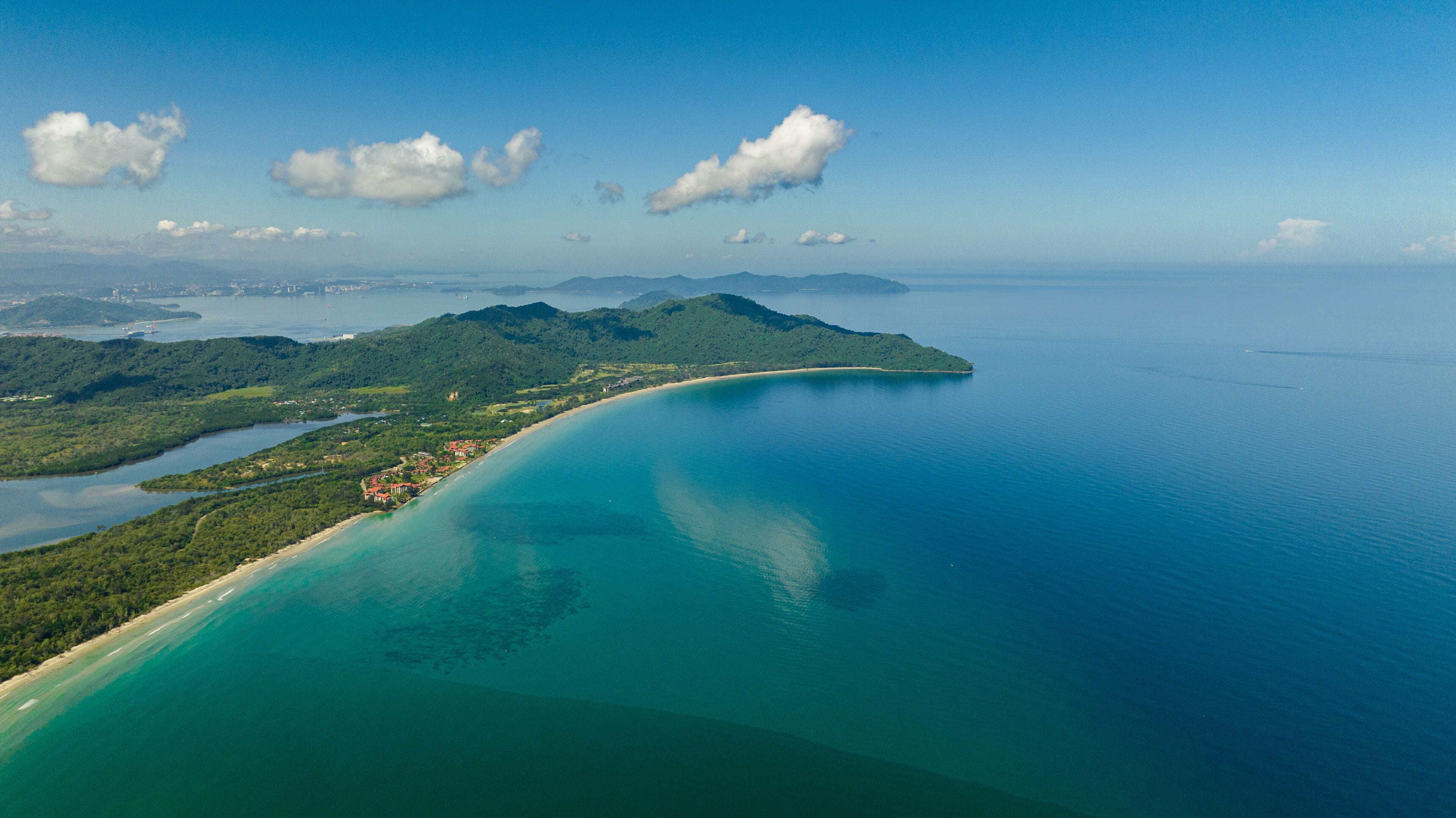 Aerial view of Borneo island coastline with beach and Kota Kinabalu city view. Malaysia.