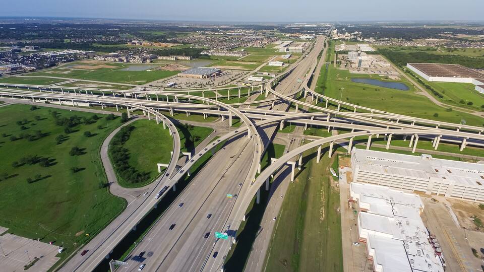 An aerial view of a complex highway interchange with multiple overpasses and connecting roads.