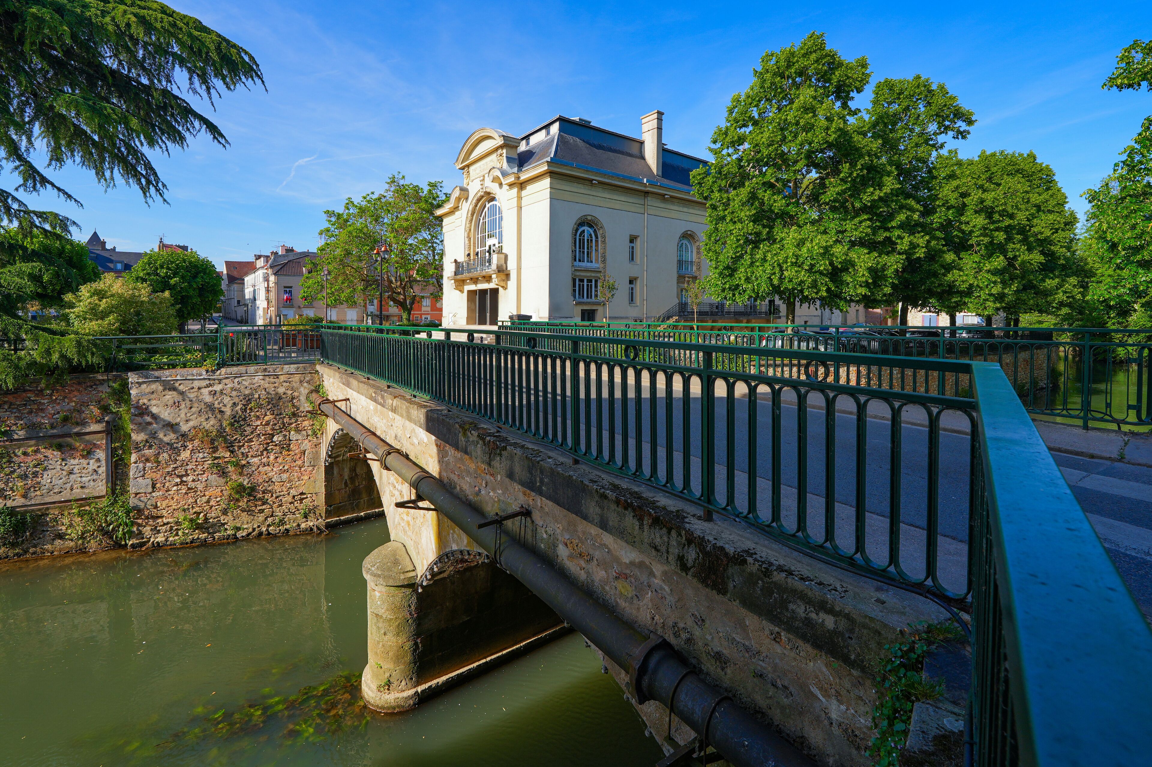 Bridge spanning the Grand Morin river in front ot the Italian-style Municipal Theatre of Coulommiers in the French department of Seine et Marne in Paris region, France