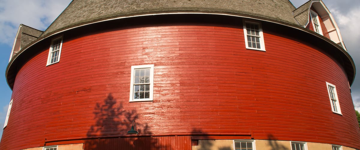 A red cylindrical building with a domed roof and multiple windows.