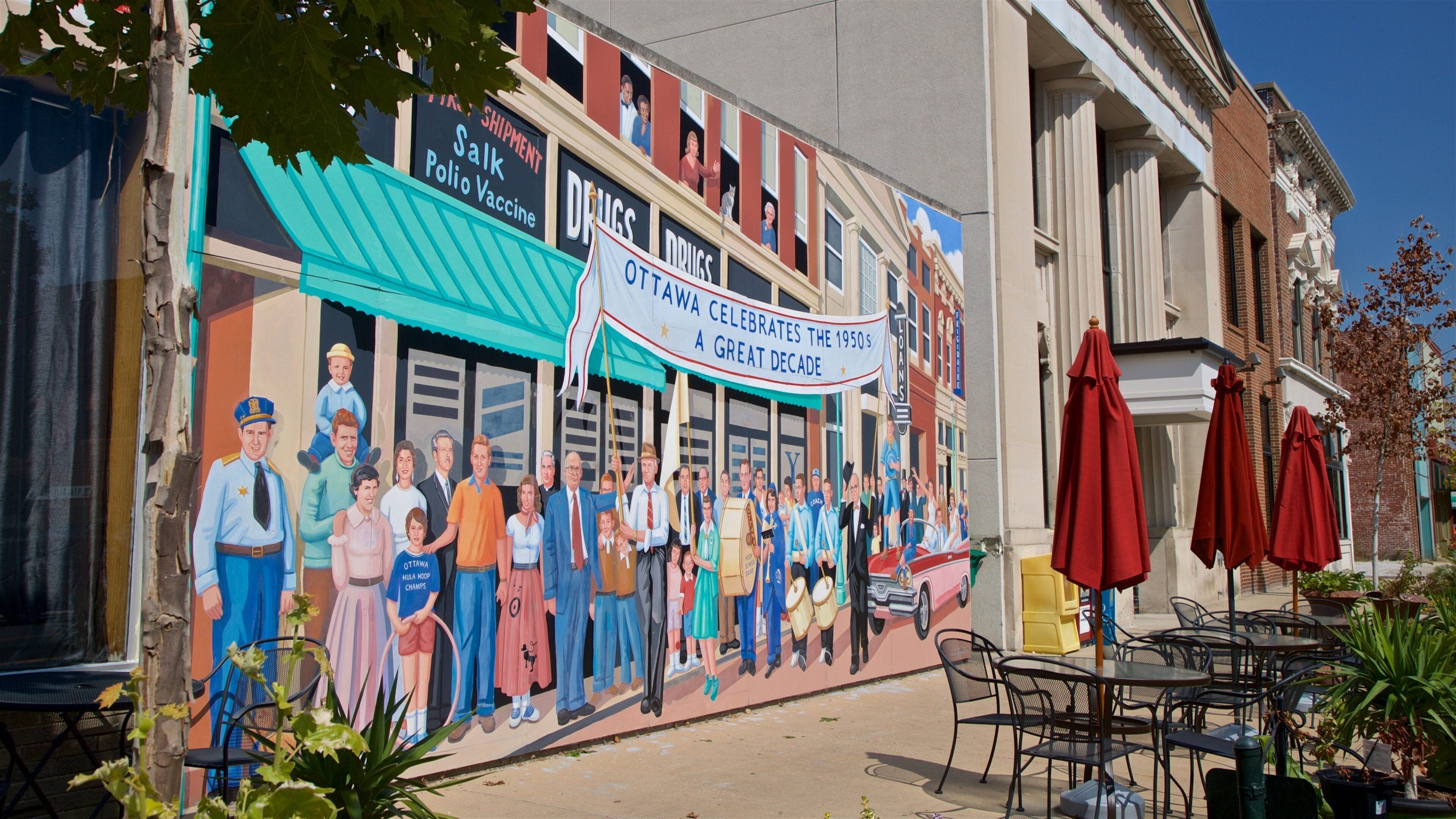 A mural on a building depicting a group of people in various outfits, with a banner reading "Ottawa Hula Hoop Champs" and "Ottawa Celebrates the 1950s."