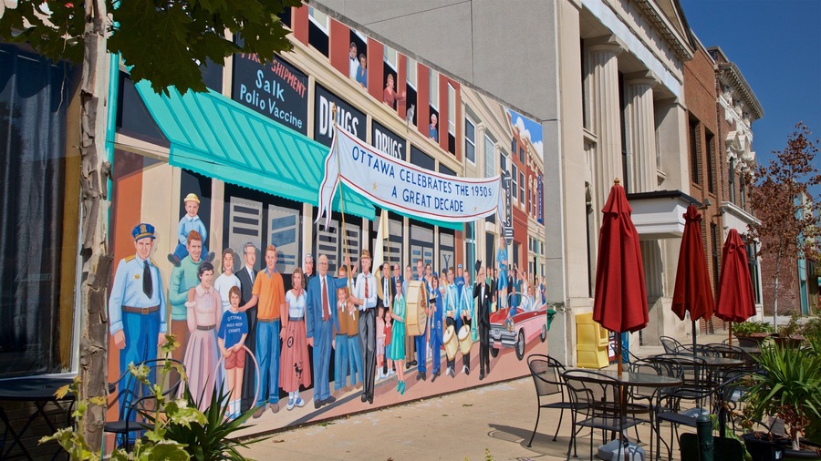 A mural on a building depicting a group of people in various outfits, with a banner reading "Ottawa Hula Hoop Champs" and "Ottawa Celebrates the 1950s."