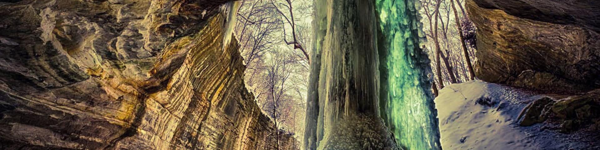 Frozen waterfall in Ottawa canyon at Starved Rock state park. The algae trapped in the ice causes a green glow when the sun shines through it.
