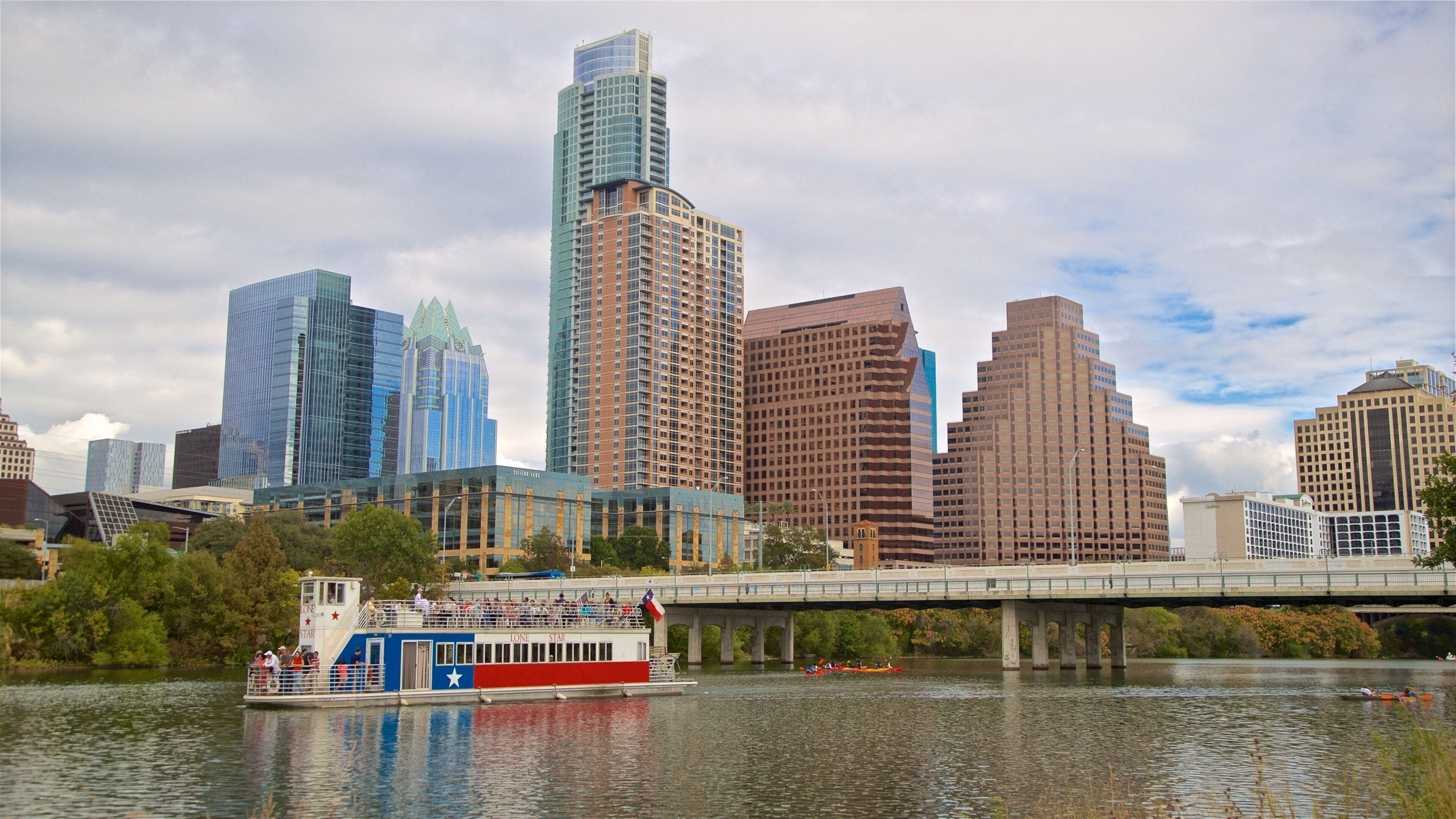 Hill Country showing a ferry, a city and a river or creek