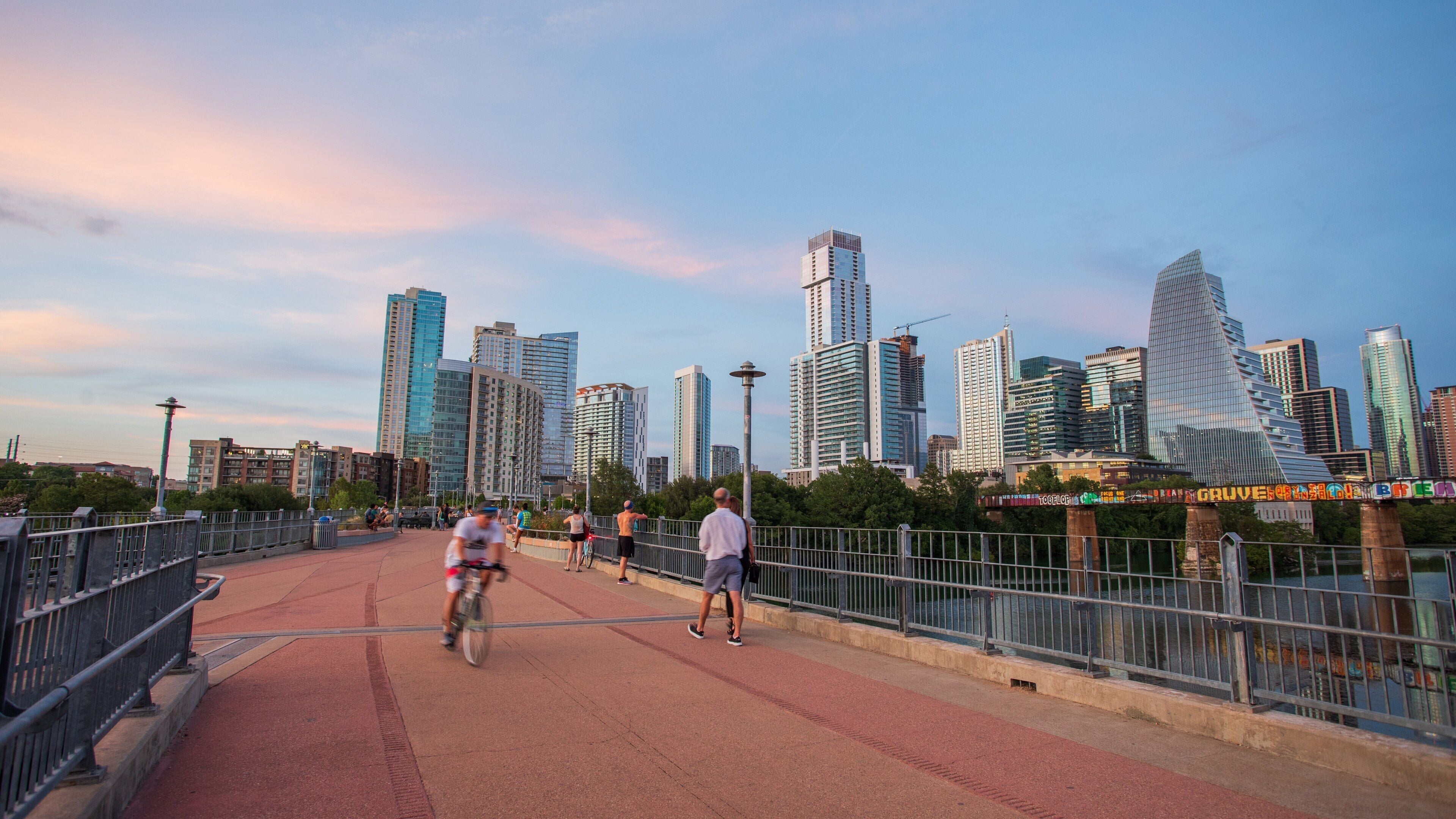 Downtown Austin showing a sunset, a city and street scenes