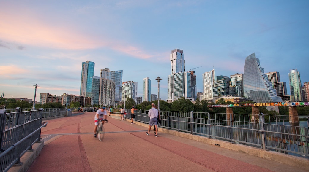 Downtown Austin showing a sunset, a city and street scenes