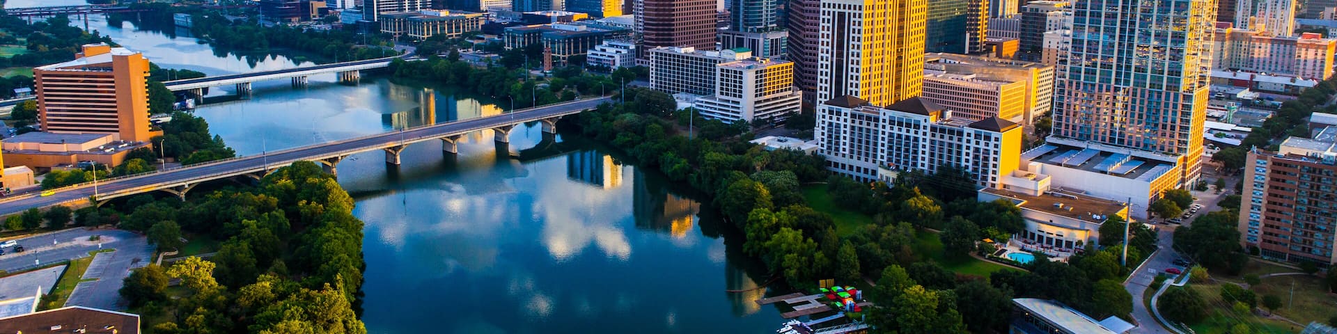 Austin Texas USA sunrise skyline cityscape over Town Lake or Lady Bird Lake with amazing reflection. Skyscrapers and Texas capital building in distance you can see the entire city during summer; Shutt