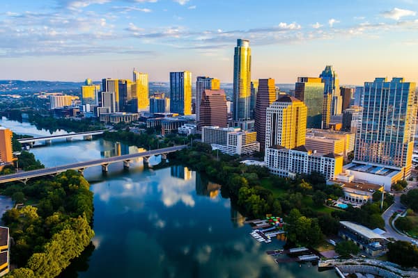 Austin Texas USA sunrise skyline cityscape over Town Lake or Lady Bird Lake with amazing reflection. Skyscrapers and Texas capital building in distance you can see the entire city during summer; Shutt