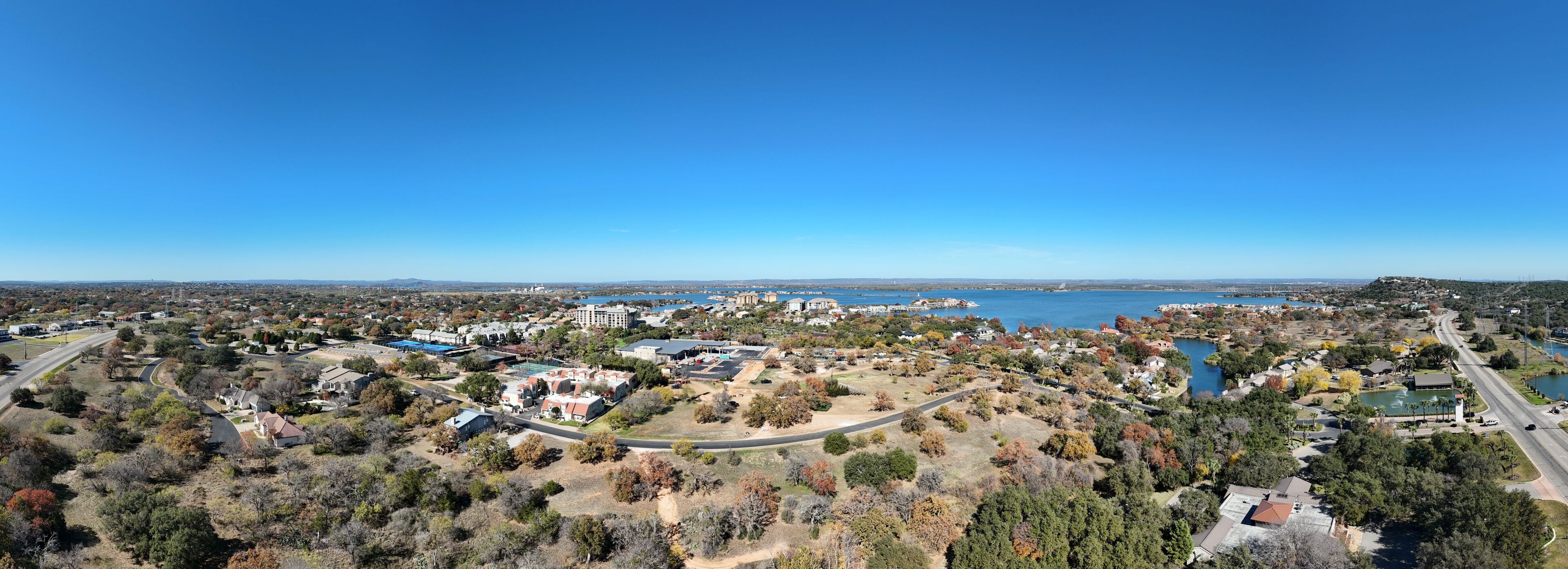 A coastal town with a marina, residential areas, and a large body of water.