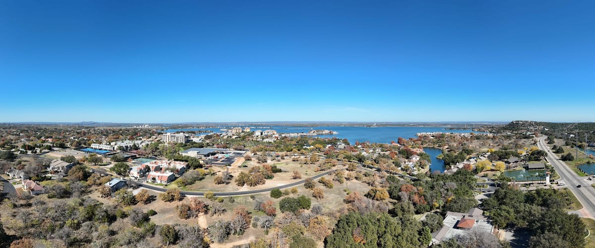 A coastal town with a marina, residential areas, and a large body of water.
