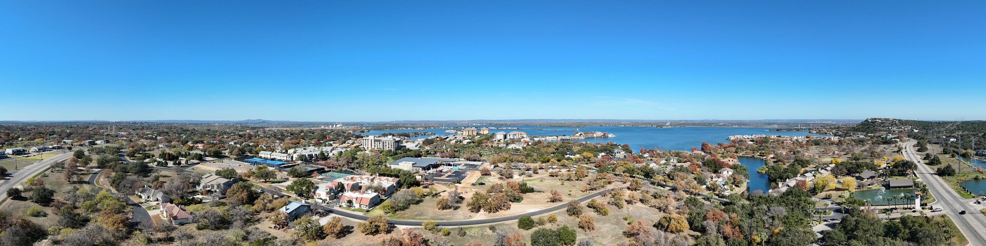 A coastal town with a marina, residential areas, and a large body of water.