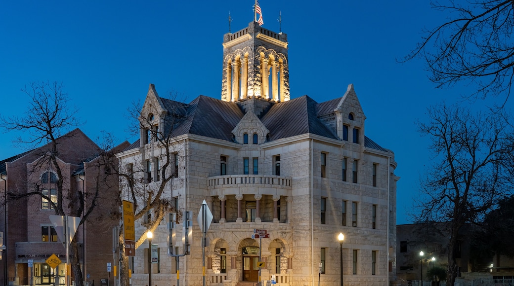 A historic building with a clock tower and a large arched entrance.