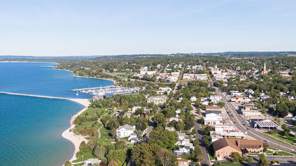 A coastal town with a marina, residential areas, and a church steeple.