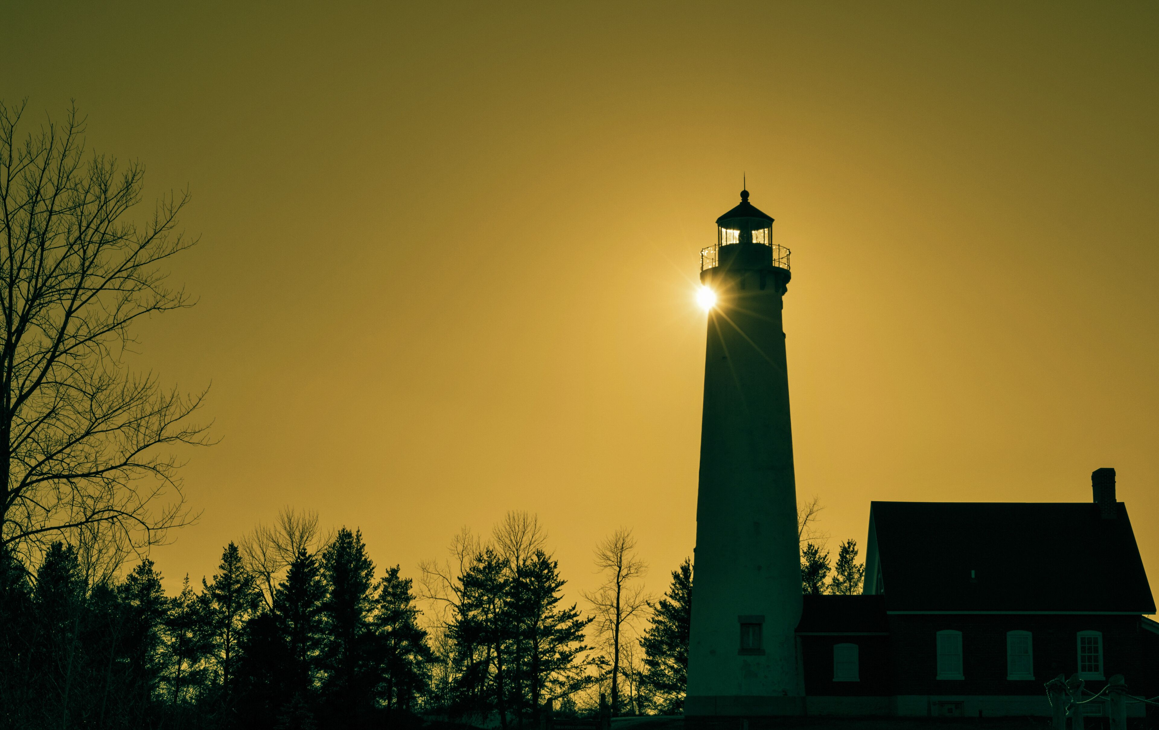 The Light Shines On. The Tawas Point Lighthouse encased in the light of the setting sun. Tawas State Park. Tawas City, Michigan.