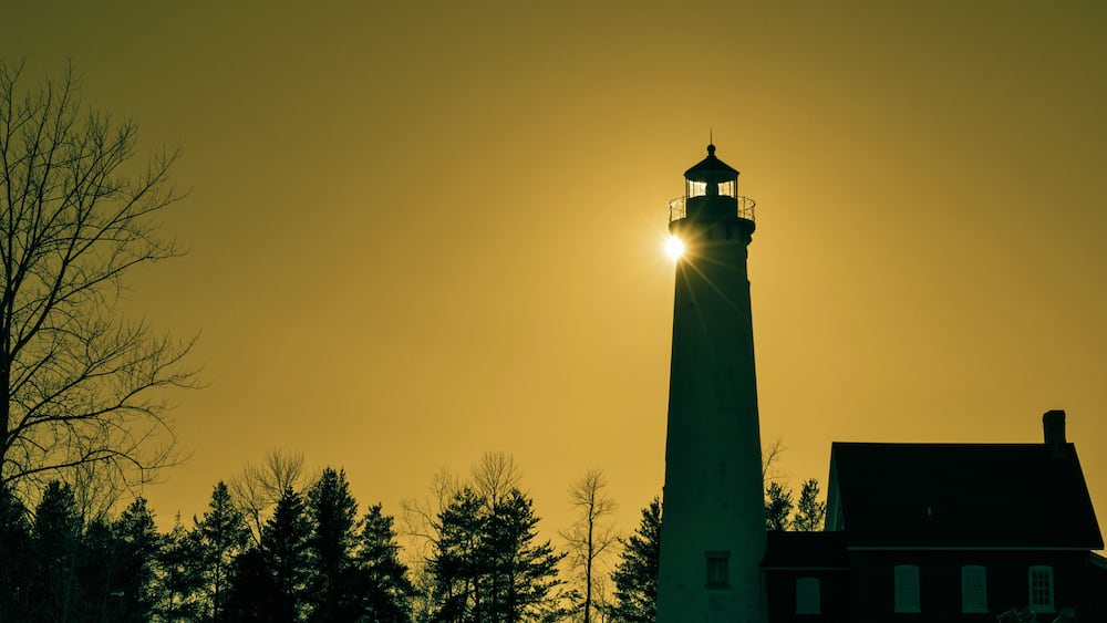 The Light Shines On. The Tawas Point Lighthouse encased in the light of the setting sun. Tawas State Park. Tawas City, Michigan.