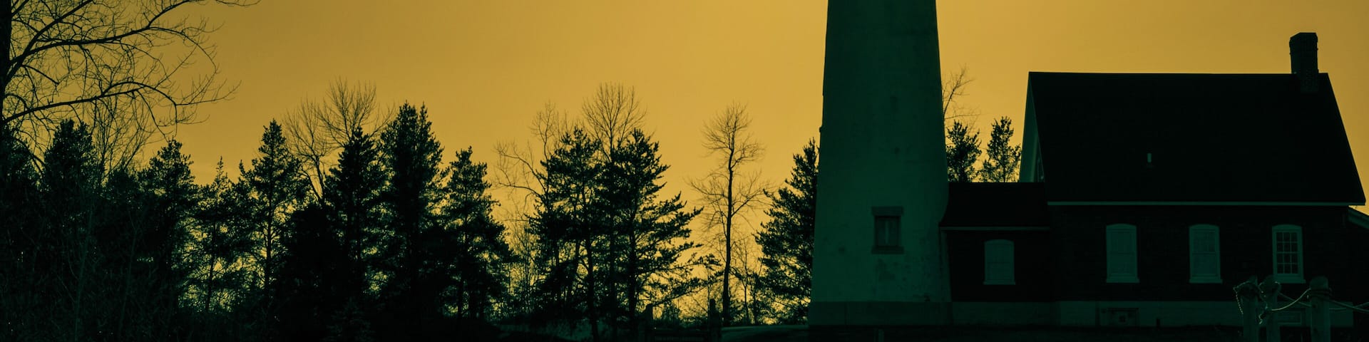 The Light Shines On. The Tawas Point Lighthouse encased in the light of the setting sun. Tawas State Park. Tawas City, Michigan.