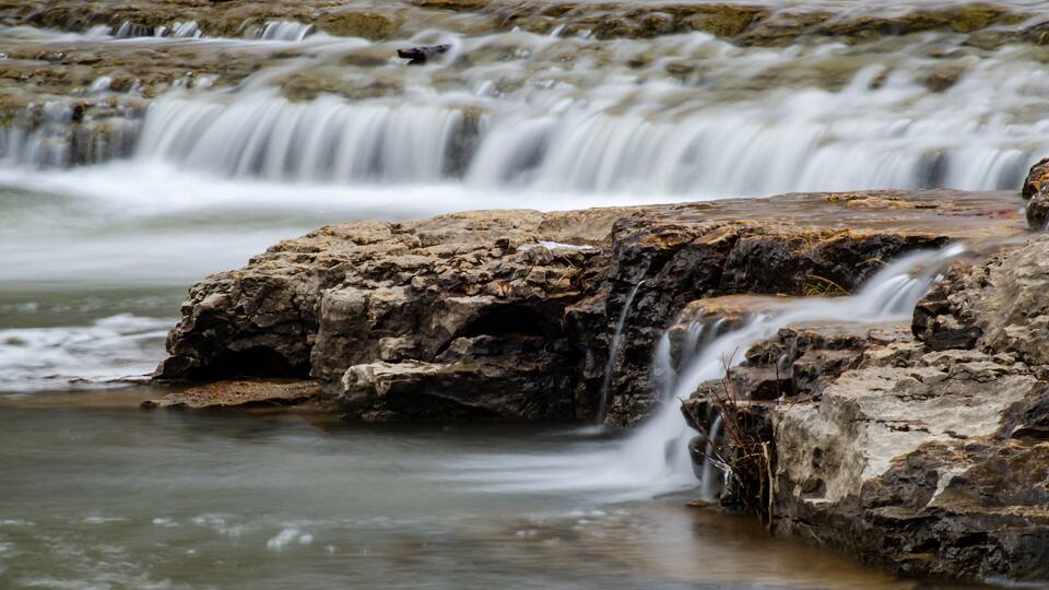 A waterfall cascading over rocky terrain.