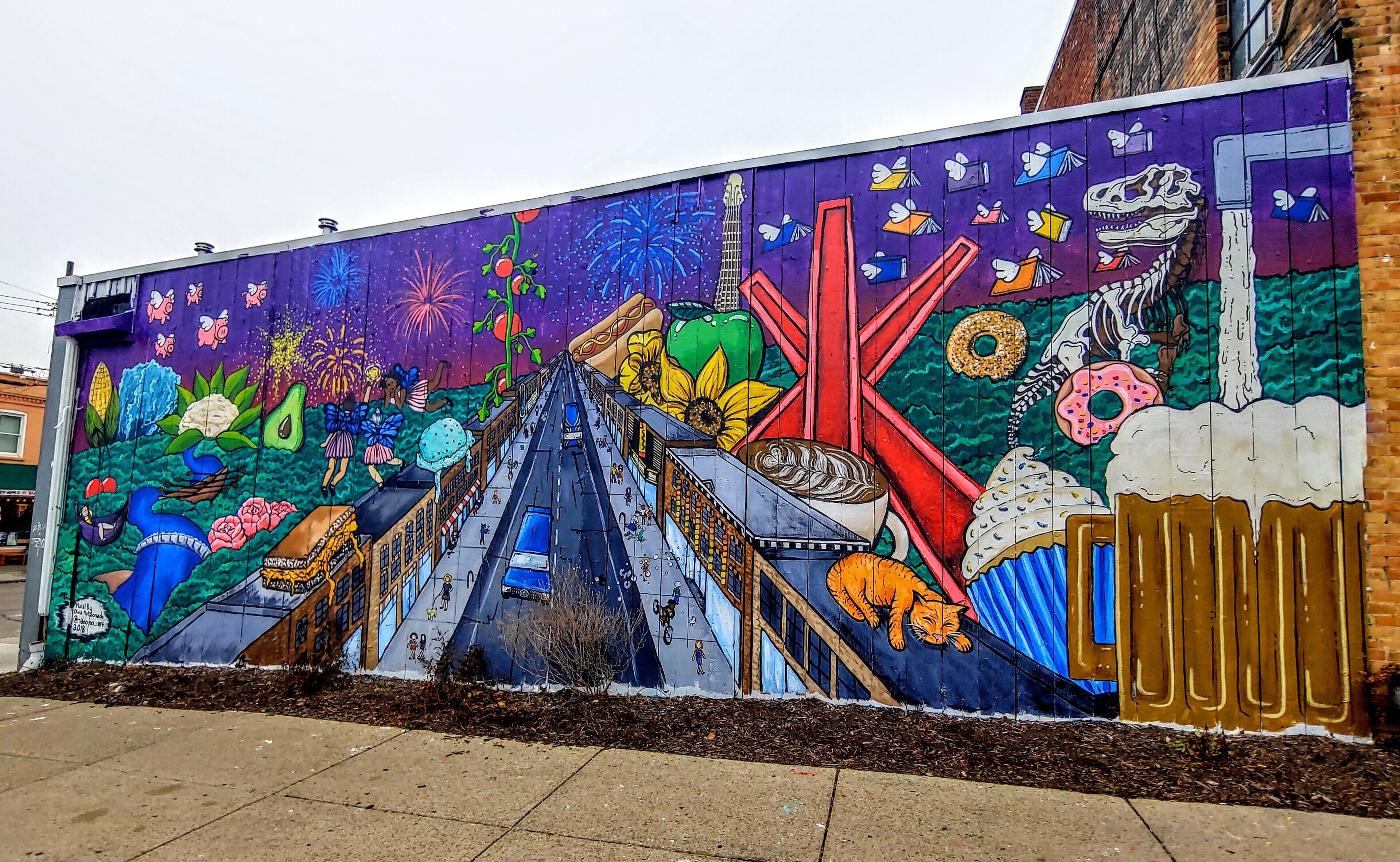 A mural featuring 25 Ann Arbor-themed references on the back of the Ann Arbor Art Center by seventeen year old artist Olivia Maldonado.