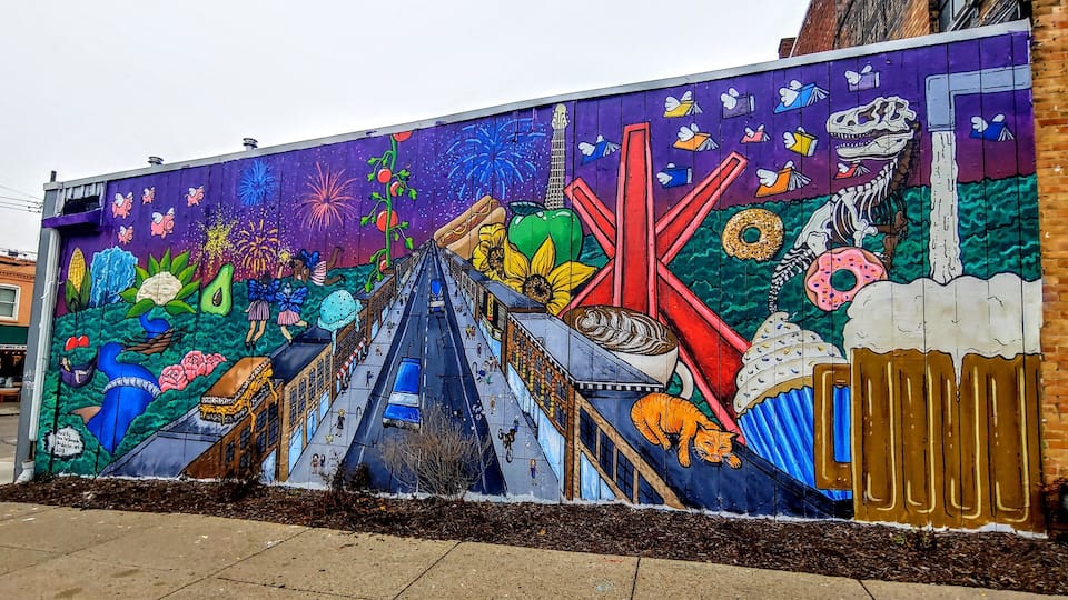 A mural featuring 25 Ann Arbor-themed references on the back of the Ann Arbor Art Center by seventeen year old artist Olivia Maldonado.