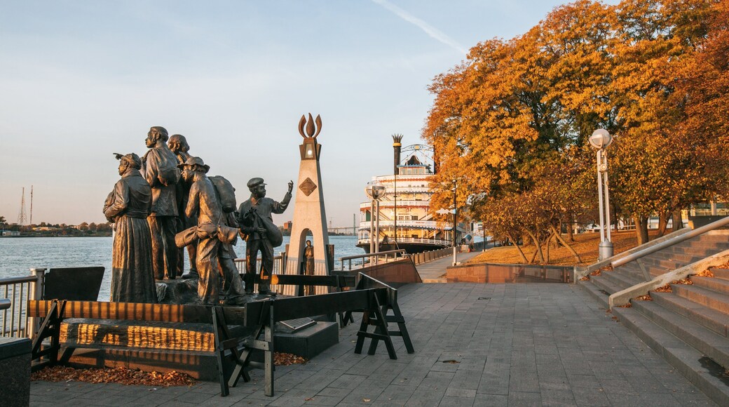 Downtown Detroit which includes a statue or sculpture, a park and a river or creek