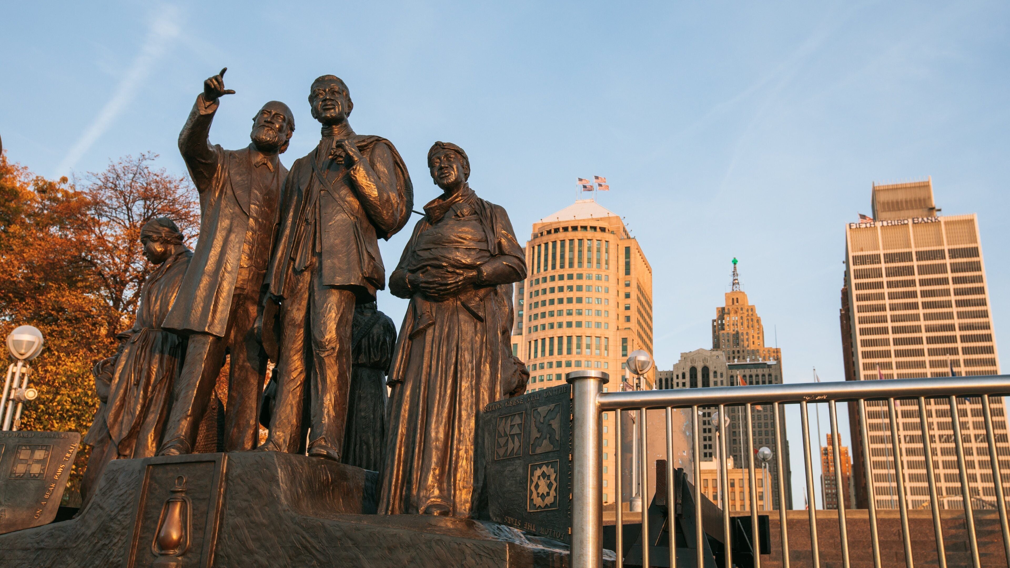 Downtown Detroit which includes a city and a statue or sculpture