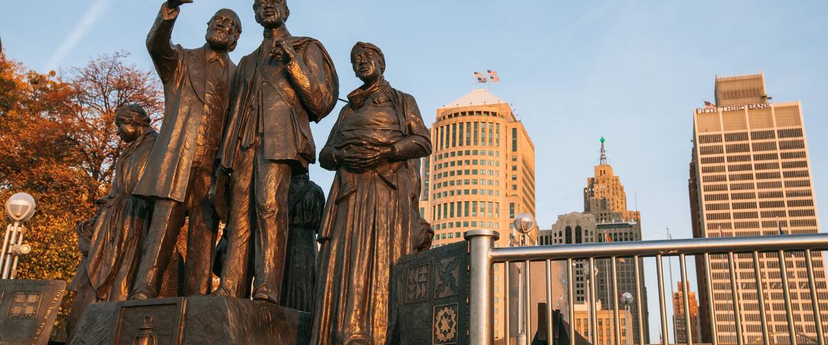 Downtown Detroit which includes a city and a statue or sculpture
