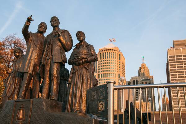 Downtown Detroit which includes a city and a statue or sculpture