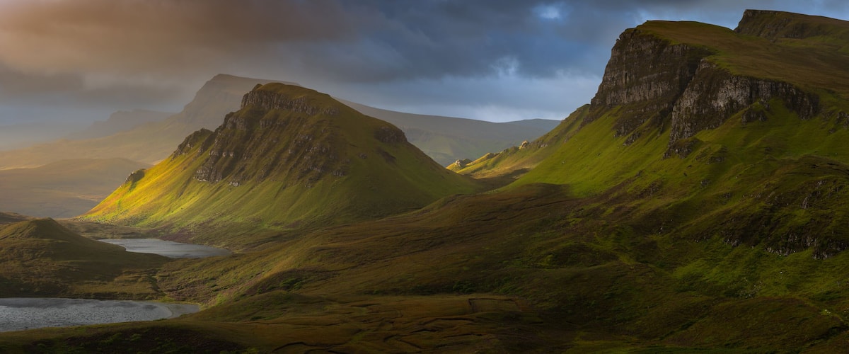 Dramatic mountains of the Isle of Skye seen from viewpoint on the Quiraing. Large panorama with dark moody clouds. Scotland landscapes, Inner Hebrides, UK.