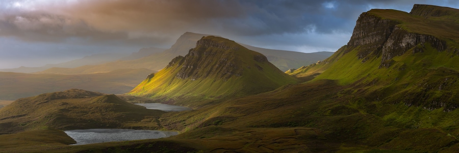 Dramatic mountains of the Isle of Skye seen from viewpoint on the Quiraing. Large panorama with dark moody clouds. Scotland landscapes, Inner Hebrides, UK.