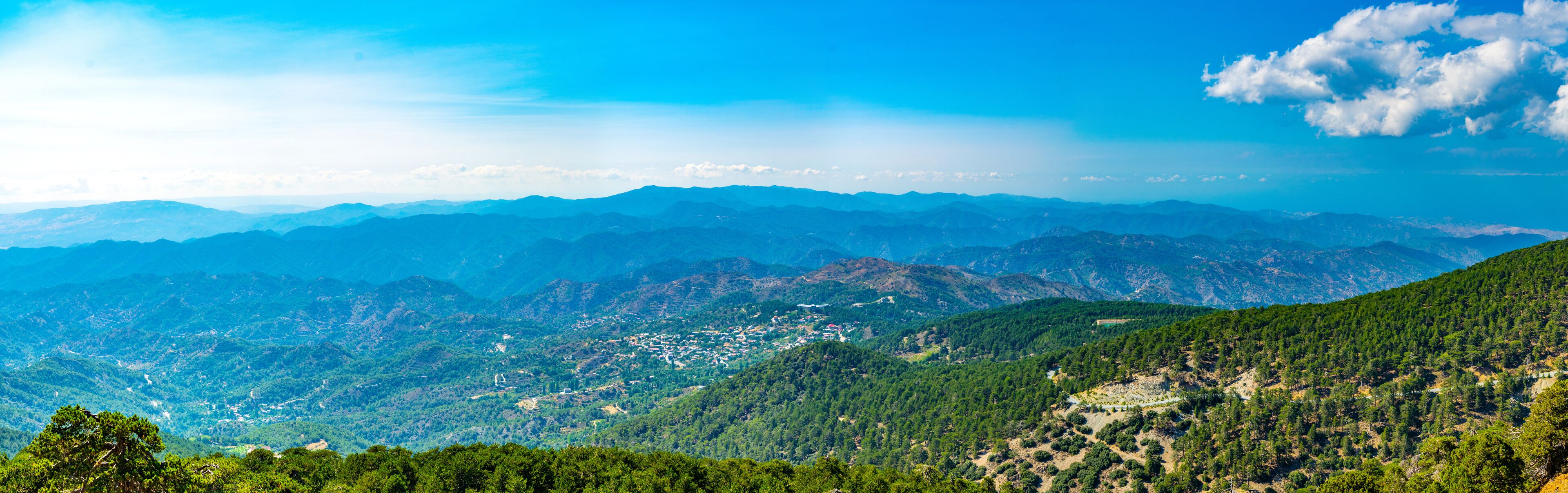 A mountainous landscape with a town nestled in the valley.