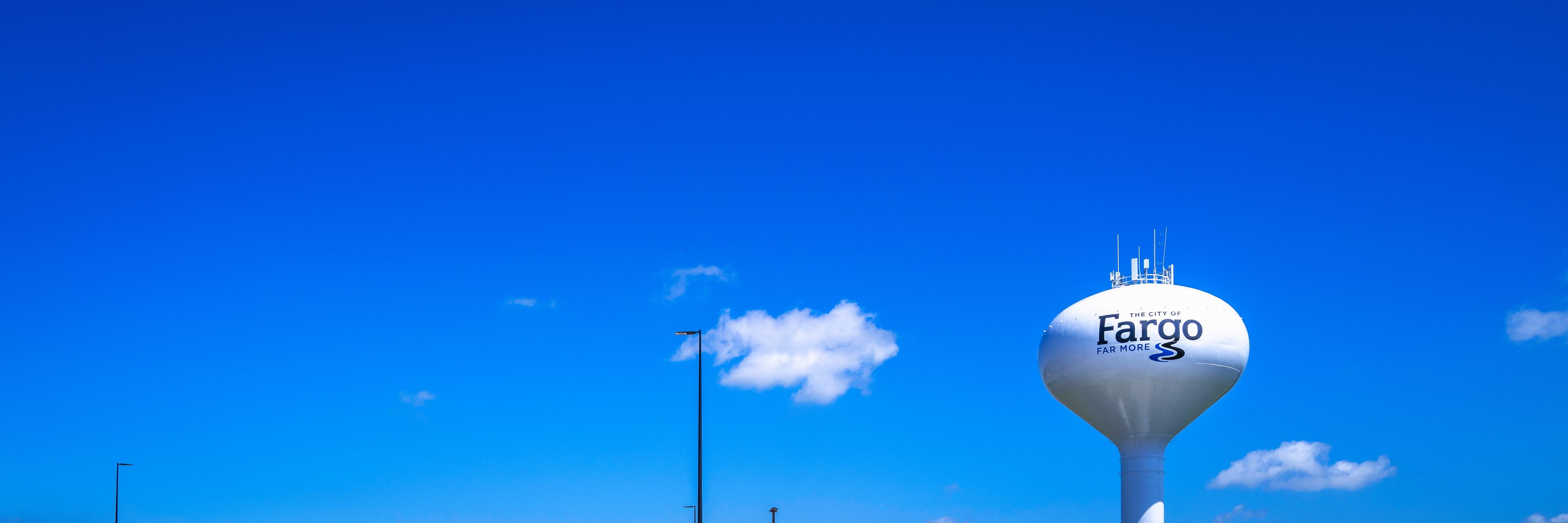 A water tower with the logo of The City of Fargo and the slogan "Far More."