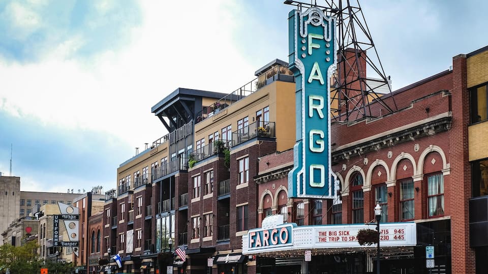 A vintage theater marquee with the name 'FARGO' and a classic movie theater facade.