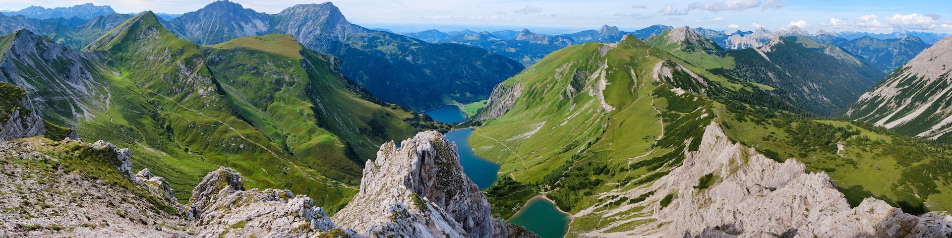 View from Lachenspitze mountain peak towards Traualpsee and Vilsalpsee lakes, at the end of the via ferrata tour. Panorama, adventure, Summer, Austria.