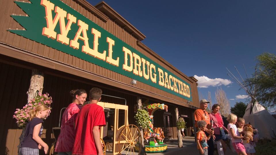 A building with a sign reading "WALL DRUG BACKYARD".