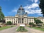 A large government building with a dome and scaffolding.