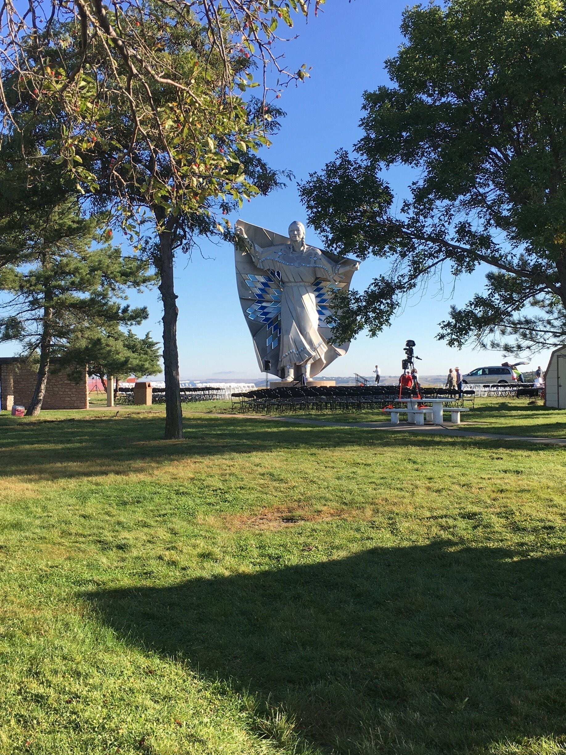 Dignity Sculpture overlooking the Missouri River. 

Dignity is a sculpture on a bluff overlooking the Missouri River near Chamberlain, South Dakota.[2] The 50-foot high stainless steel statue, by South Dakota artist laureate Dale Lamphere, depicts an Indigenous woman in Plains-style dress receiving a star quilt. According to Lamphere, the sculpture honors the culture of the Lakota and Dakota peoples who are indigenous to South Dakota.[3]