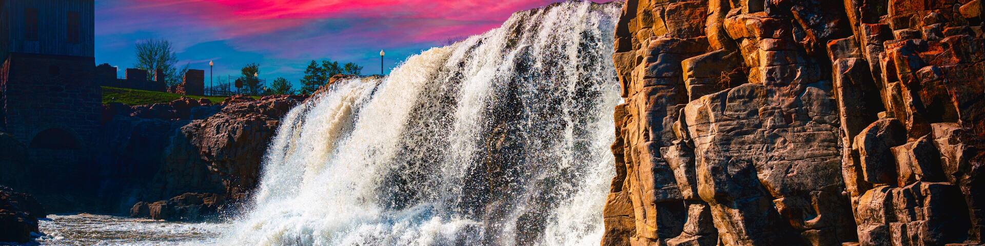Sioux Falls City Spring Landscape at the Falls Park in Sioux Falls, South Dakota, USA, dramatic sunset cloudscape and water falling in the Big Sioux River