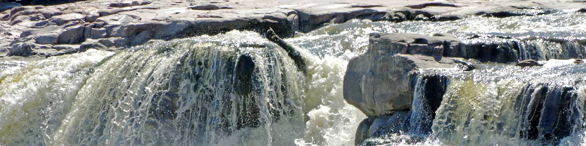 A waterfall cascading over rocks.