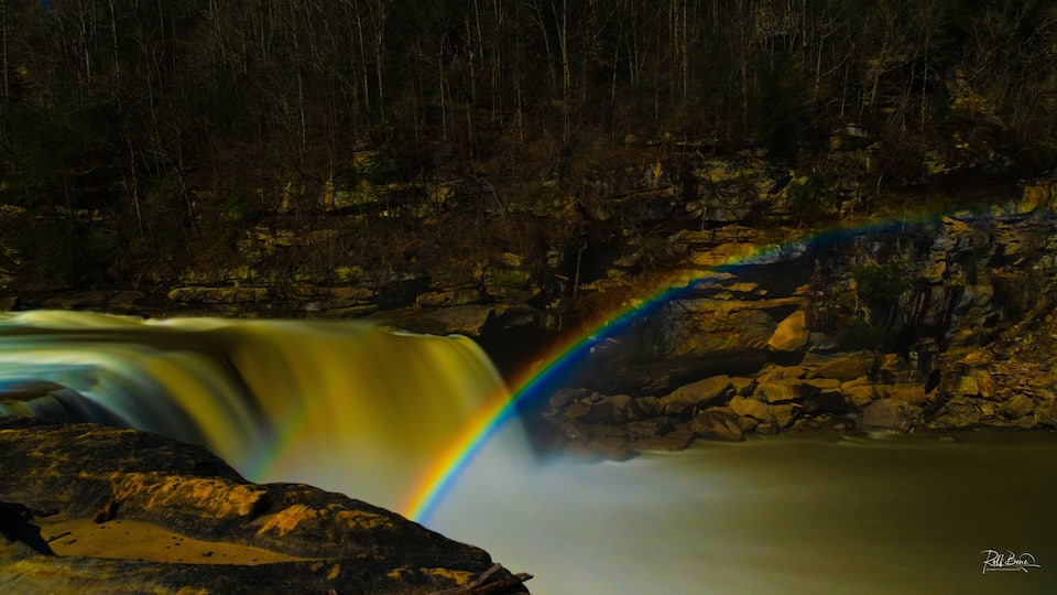 A waterfall with a rainbow.