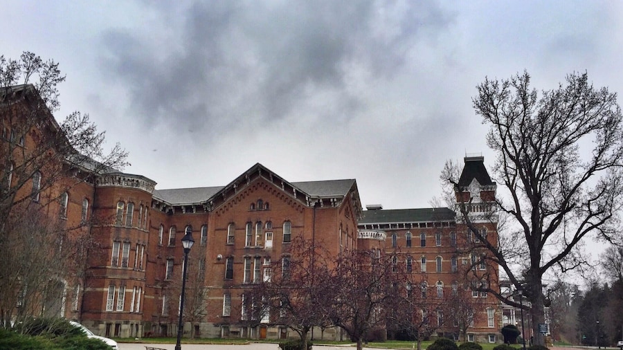 Called "The Ridges" currently, this large, looming building that overlooks Ohio University's campus was formerly a mental health hospital called the Athens Asylum for the Insane. There's a small museum inside now, and the rest of the grounds are owned by the university, but there is still certainly a chilling aspect to the building that calls to its past.
Take a walk around the grounds or visit the museum, it's something worth seeing. Behind the building is a community park with areas that would be worth visiting in warmer days. Take the road that loops up a hill