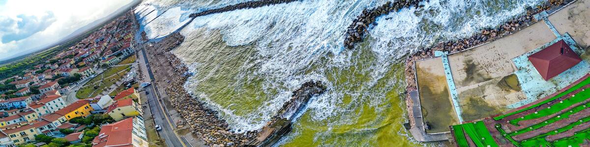Storm in Marina di Pisa, Tuscany. Fury of the waves on the coast, aerial view on a sunny morning
