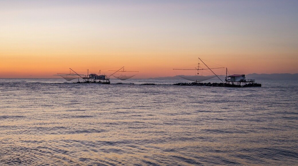 There is a lot more to Pisa than the famous Leaning Tower!
If you get some extra time, I would recommend you hit the Marina di Pisa. It is only a 20 mins drive from the city, and in my opinion it is worth the detour.
The walk at sunset by the Arno bank in the estuary is brilliant. This is from there that I got this photo of those fishing huts.
Also, the Yacht Club in the middle of the marina is an amazing spot to watch sunset and enjoy a Spritz!