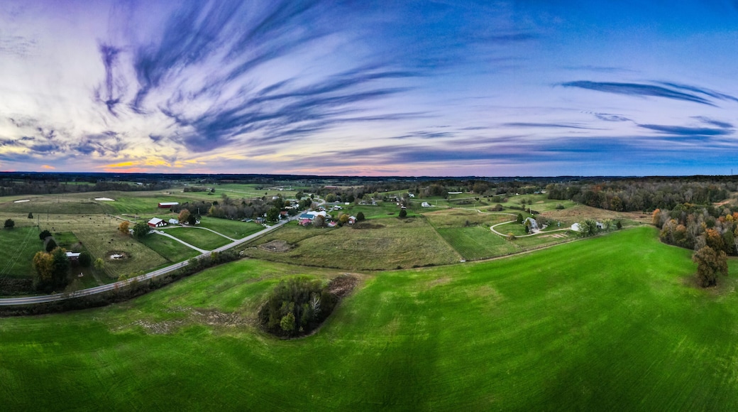 Bright green meadow around Glasgow, Kentucky with colorful sky sunset