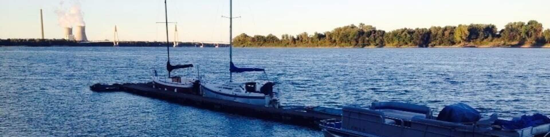 An evening sail boat ride through the Ohio river owned by Kentucky. Behind is one of the worlds most productive power plants.