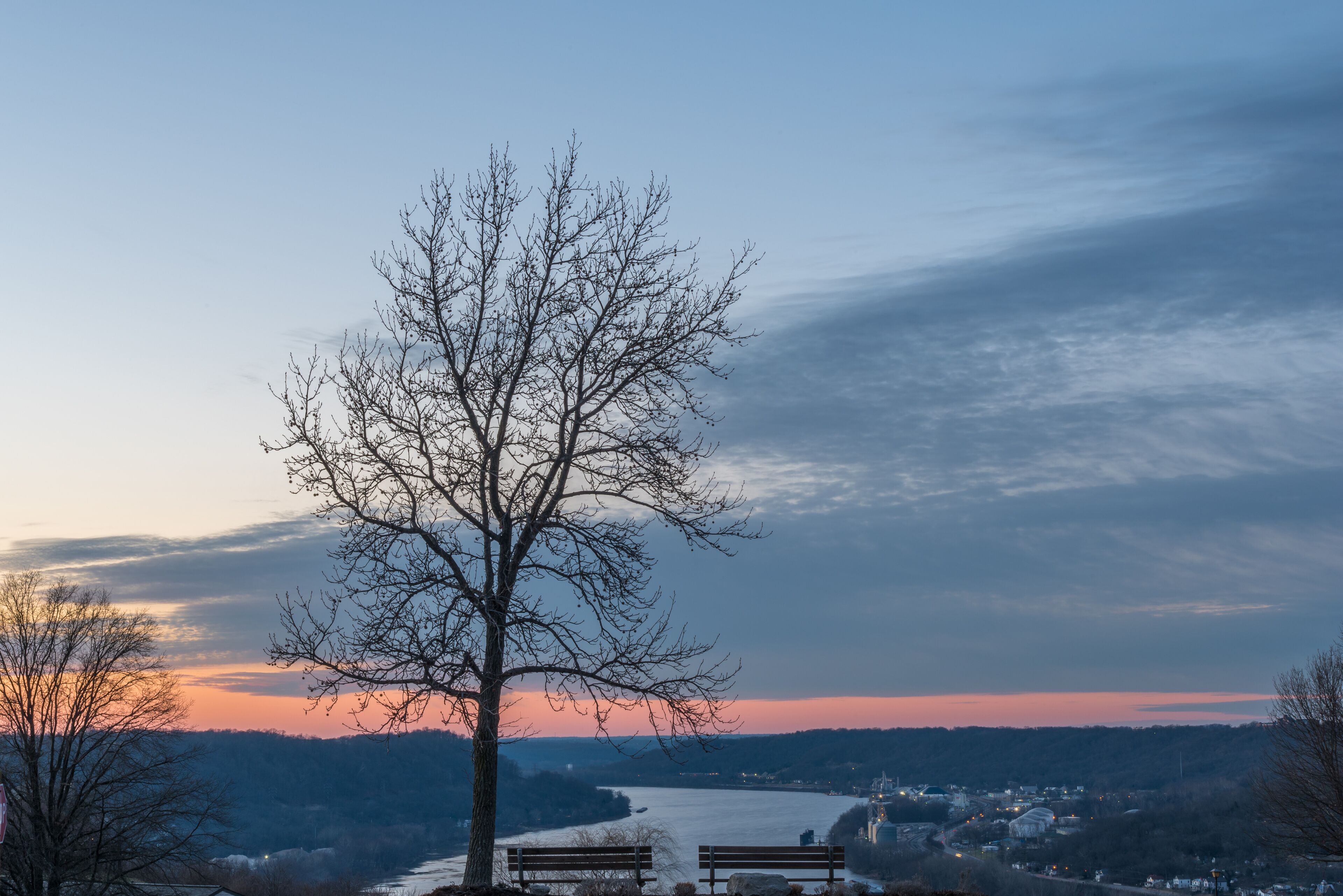 peaceful sunset next to the park benches